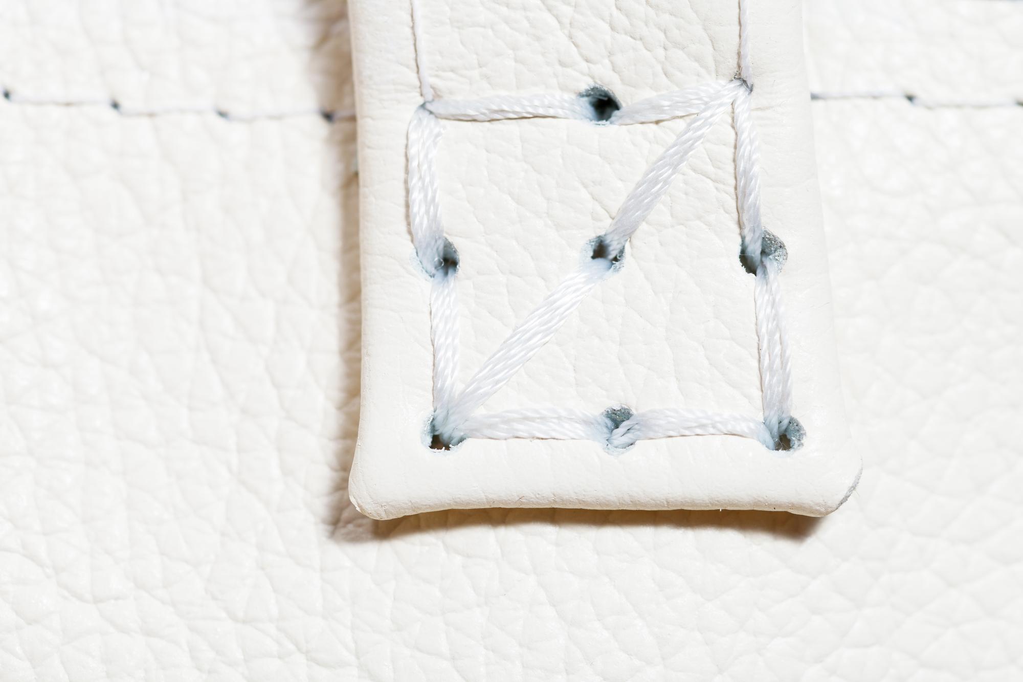 Finished embroidered patch sewn onto garment